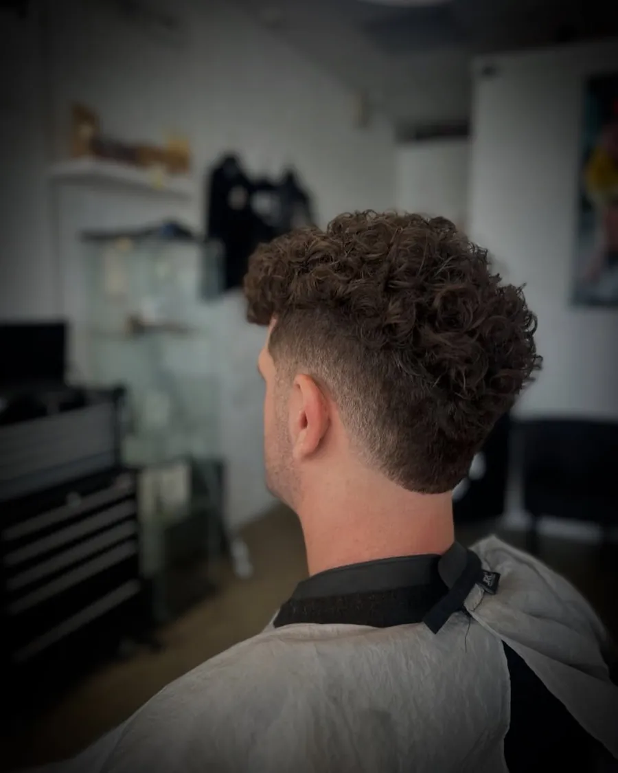 Curly top with a blended fade, cut at Chop Chopp's Barbershop