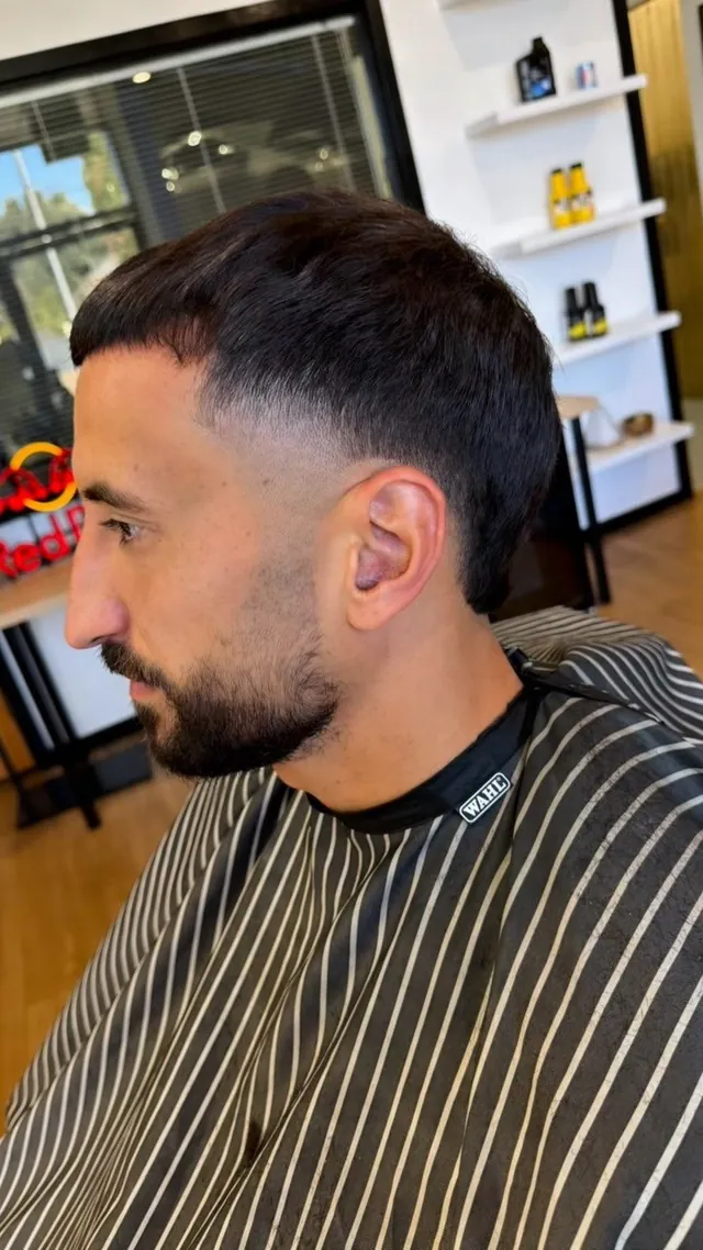 Skin fade with a shaped beard, cut at Chop Chopp's Barbershop